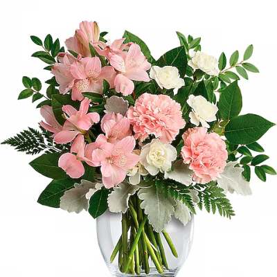 Pink and white flowers arranged in a clear glass vase