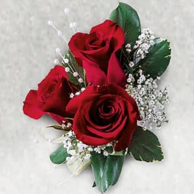 Three red roses with white baby's breath and greenery