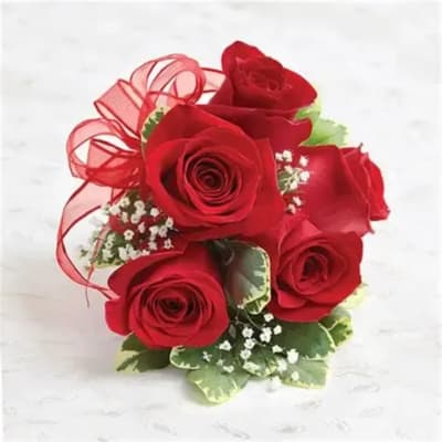 Bouquet of red roses with a red ribbon and small white filler flowers
