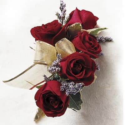 Corsage with red roses and gold ribbon on a white background