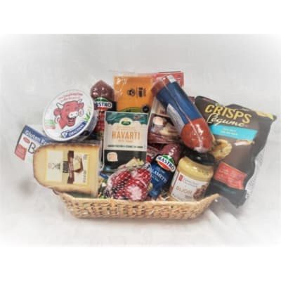 Gift basket with cheeses, sausage, crackers, and mustard
