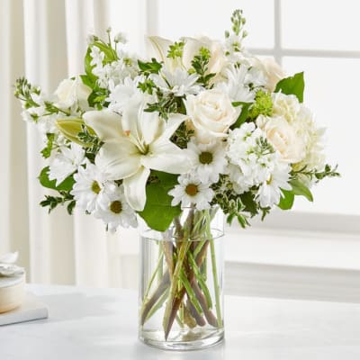 White flowers arranged in a clear glass vase