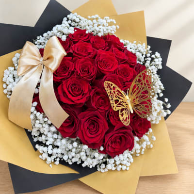 Bouquet of red roses with white baby's breath and gold ribbon accents