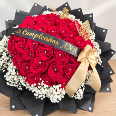 Red rose bouquet with white baby's breath, black wrap, and gold ribbon