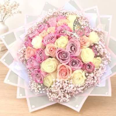 Bouquet of pastel roses with a butterfly decoration