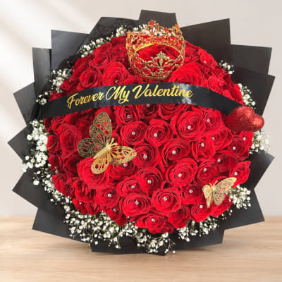 Red rose bouquet with a crown topper and black wrap