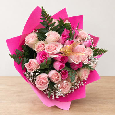 Bouquet of pink roses wrapped in bright pink paper