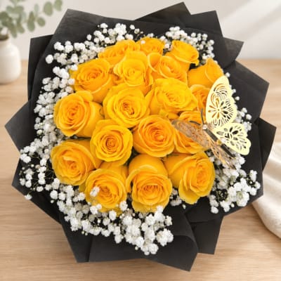 Bouquet of yellow roses with white baby's breath in black wrap