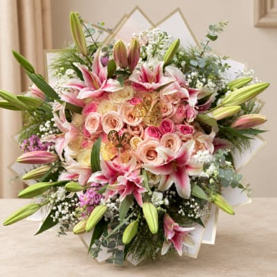 Bouquet of pink roses and lilies with white filler flowers