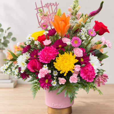 Colorful mixed bouquet in a pink vase with a Happy Birthday topper