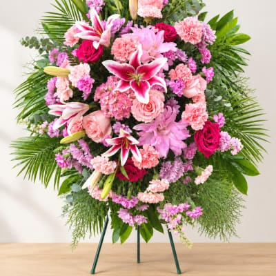Large pink and purple floral standing arrangement with lilies and roses