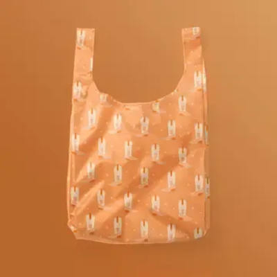 Peach reusable tote bag with a small repeating print