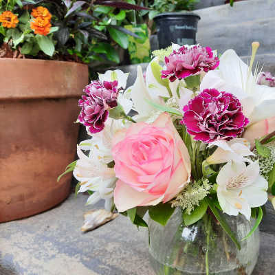 Pink rose and white lily bouquet in a glass vase