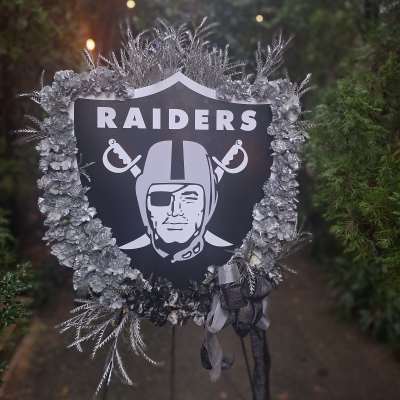 Raiders memorial wreath with silver flowers and ribbon