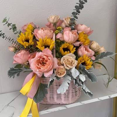 Pink and yellow flower basket with roses and sunflowers