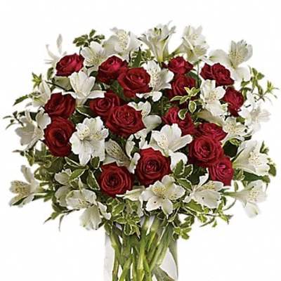 Red roses and white lilies in a clear glass vase