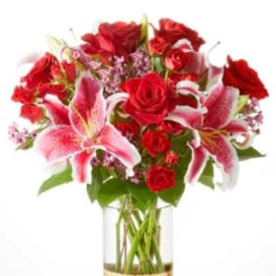 Bouquet of red roses and pink lilies in a gold vase