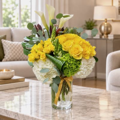 Yellow roses and white hydrangeas in a glass vase