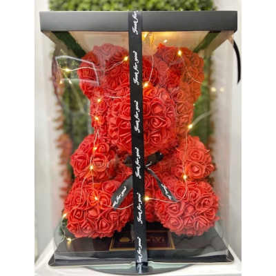 Red rose teddy bear with string lights in a clear display box with black trim