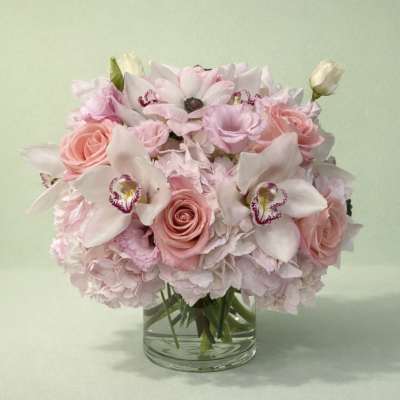Pink and white floral bouquet in a clear glass vase