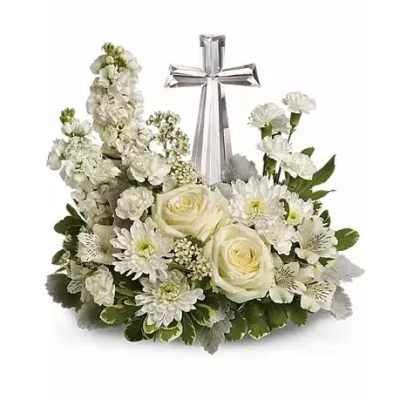 White floral arrangement with a silver cross centerpiece