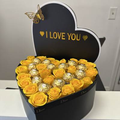 Large heart-shaped box with beautiful roses and Ferrero Rocher chocolates , Dior brand, with the phrase "I love you".