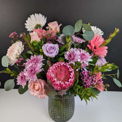 Pink and white mixed bouquet in a textured glass vase