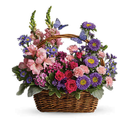 Handled wicker basket of pink roses and carnations with purple asters and decorative butterflies