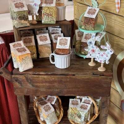 Assorted packaged snacks and decorative bunny cutouts on a rustic wooden display