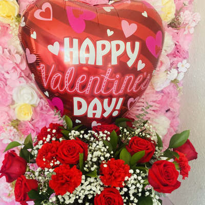 Red rose arrangement with a heart-shaped Valentine balloon and chocolates in a box