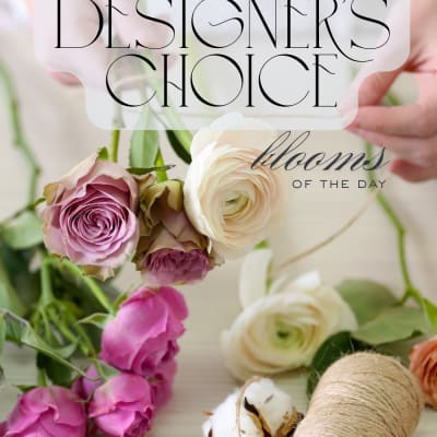 Loose pink and cream roses and ranunculus with twine and cotton labeled designer's choice blooms of the day