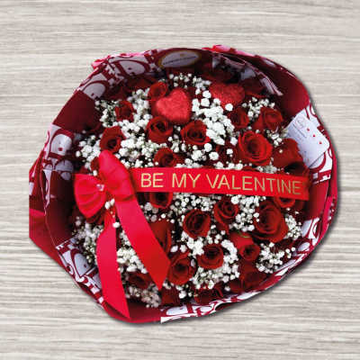 Bouquet of red roses with white baby's breath and a Valentine ribbon