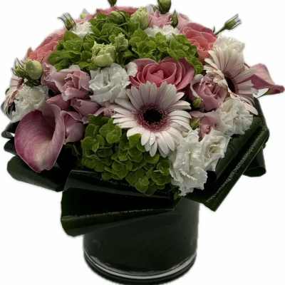 Pink and white bouquet in a black vase with green hydrangea
