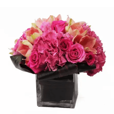 Pink and coral flower arrangement in a black vase