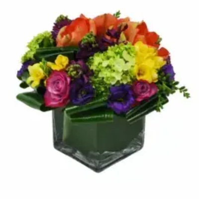 Colorful mixed bouquet in a dark green vase