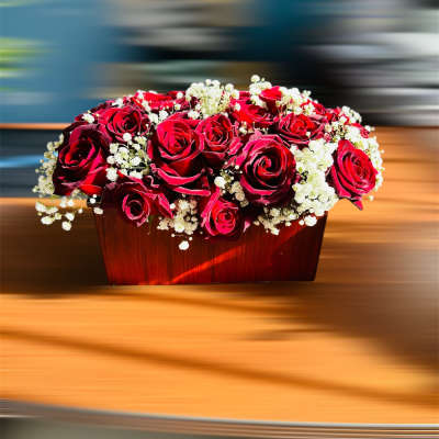 Red roses and white baby's breath in a wooden box
