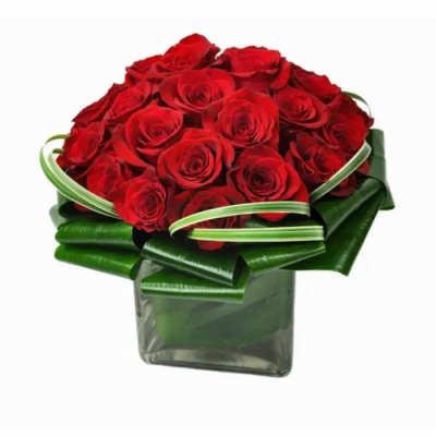 Red rose bouquet in a square glass vase with green ribbon wrap