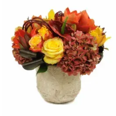 Autumn bouquet of yellow and orange flowers in a beige vase