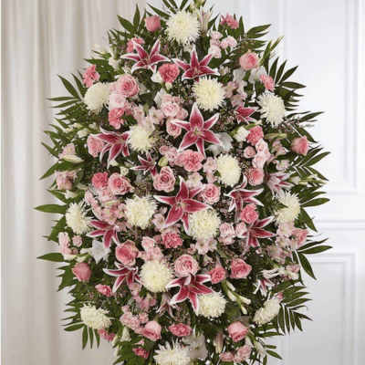 Standing spray of pink and white flowers with lilies and roses