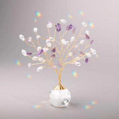 Small gold wire tree with clear and purple crystals on a faceted crystal base