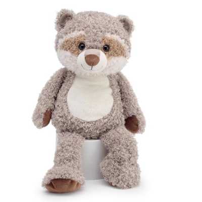 Soft raccoon stuffed animal sitting upright on a small white cylinder