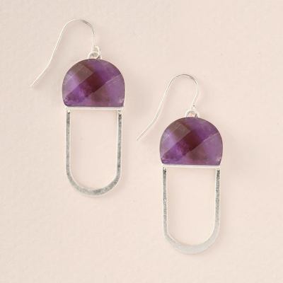 Pair of silver drop earrings with faceted purple semicircle stones on a light background