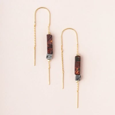 Long gold threader earrings with rectangular marbled stone beads on a light background