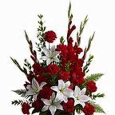 Red and white floral arrangement in a dark vase
