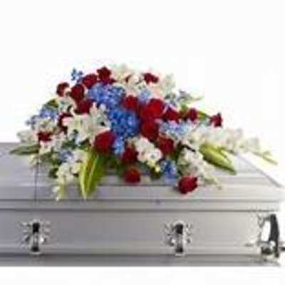 Casket spray with red, white, and blue flowers