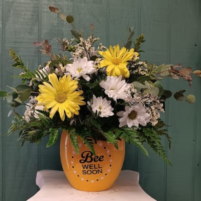 Yellow and white daisy bouquet in a bee-themed pot