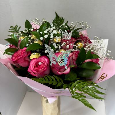 Pink rose bouquet with baby's breath, gold chocolates, and butterfly picks