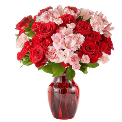 Red roses and pink carnations in a red glass vase