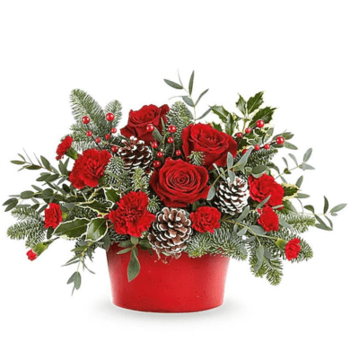 Red roses and carnations in a red container with pinecones