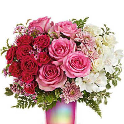 Pink and red roses with white flowers in a pink glass vase